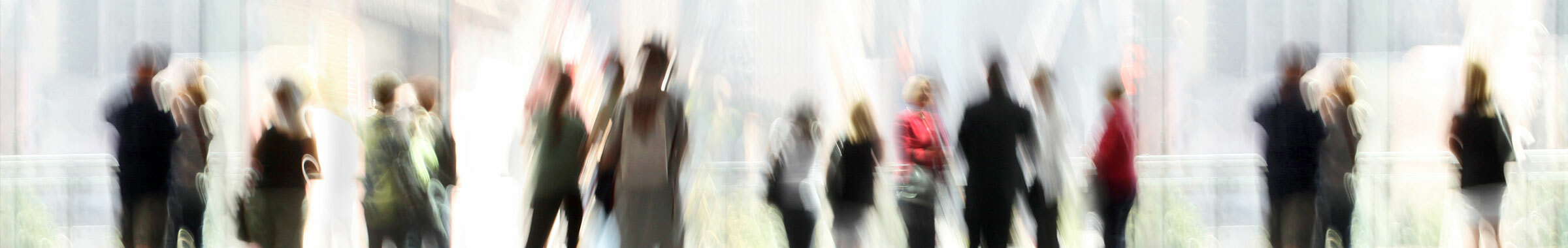crowd of blurred people walking in an office lobby