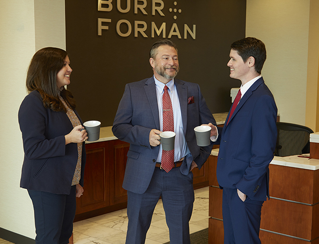 Three business people with coffee